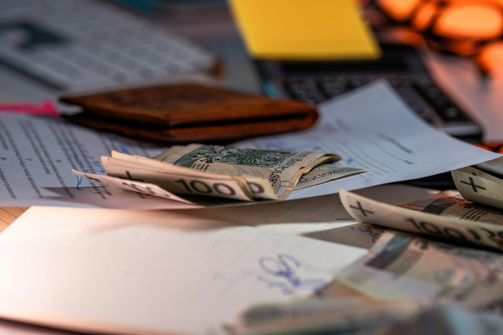 Money and documents on a desk for VAT and payroll returns
